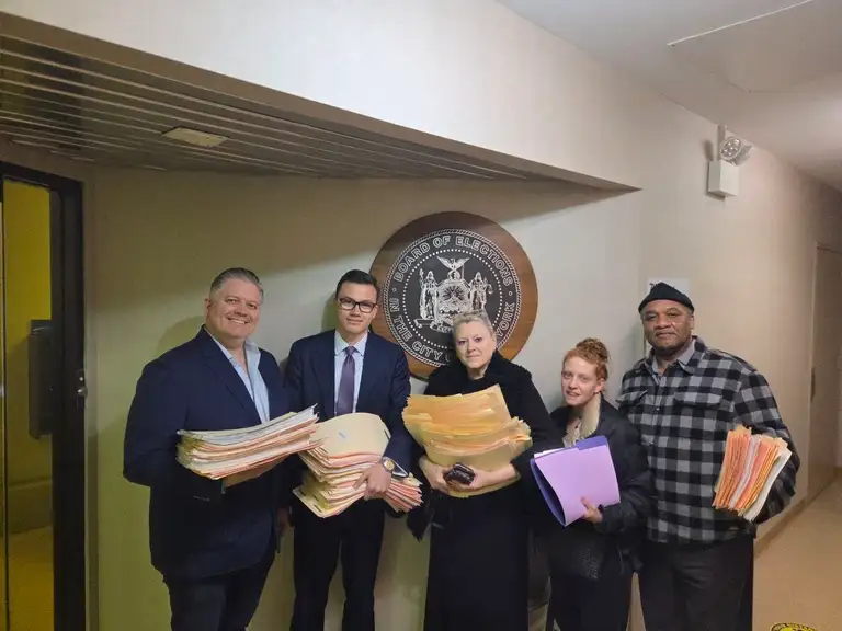 Brooklyn GOP volunteers holding stacks of petition sheets at the NYC Board of Elections