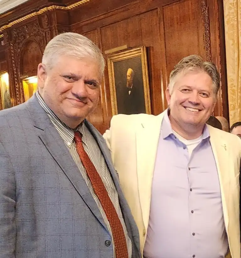 Two guests at a Brooklyn GOP reception in a wood-paneled hall